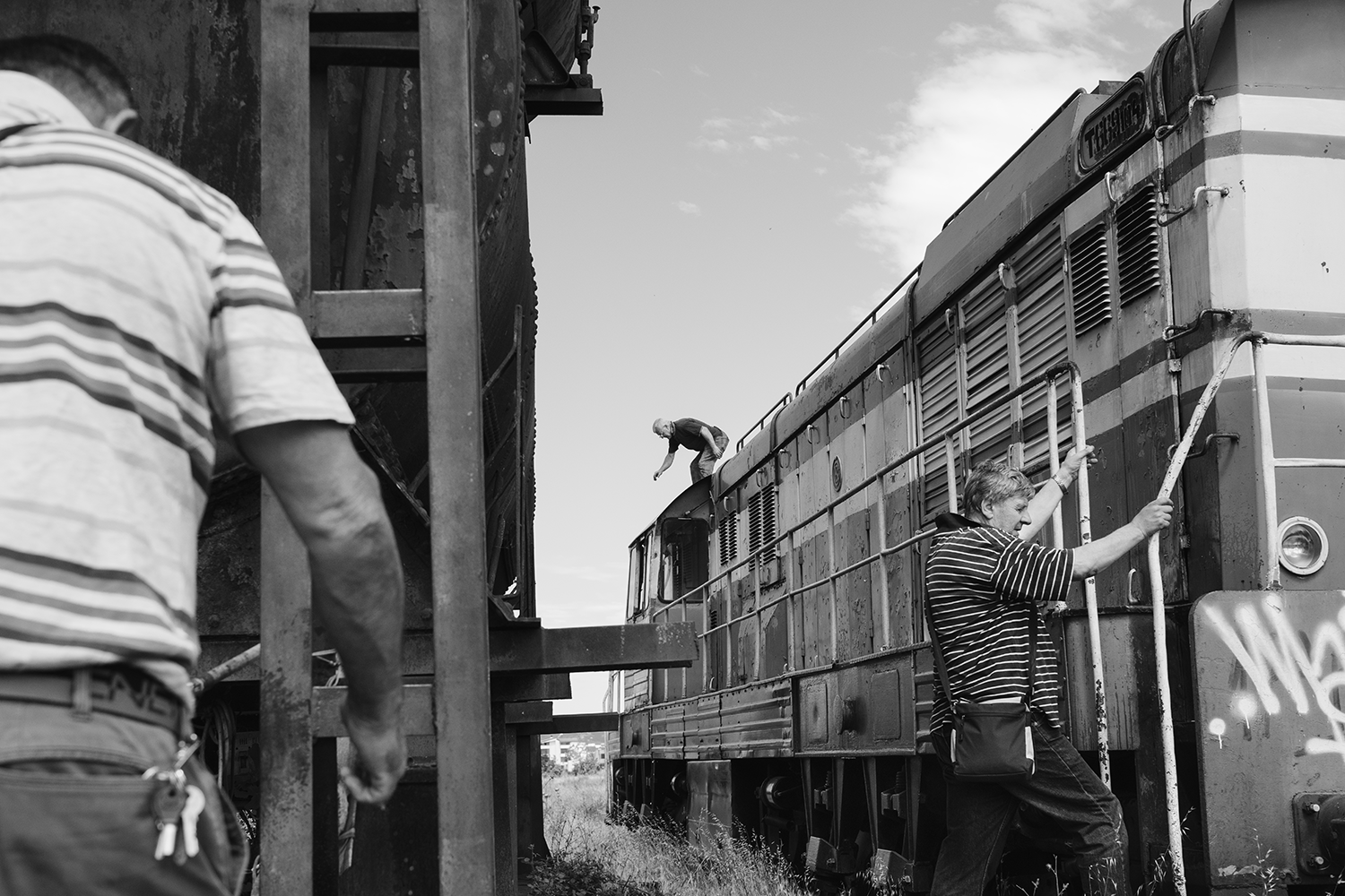 Men board and jump from a train Men board and jump from a train